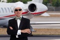 Elegant chef posing in front of a jet