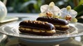 Delicious Chocolate Eclairs with Orchid Garnish on Elegant Plate Royalty Free Stock Photo