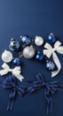 Elegant Christmas flat lay with blue, white, and silver ornaments and ribbons on a navy background. This modern composition Royalty Free Stock Photo