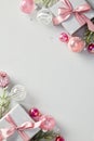 Elegant Christmas poster: Grey gift boxes with pink ribbon, festive balls, fir branches. The festive design, with its abstract