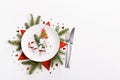 Elegant christmas table setting design captured from above top view, flat lay. Empty white plate, glass, cutlery, candy Royalty Free Stock Photo