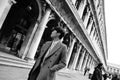 Elegant chinese man walking in street in Venice. Italy