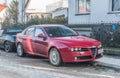 Elegant classic red Alfa Romeo 159 parked