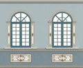 Elegant classical facade with arched windows on blue wall Royalty Free Stock Photo