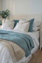 Elegant coastal style bedroom with teal and white bedding and natural light Royalty Free Stock Photo