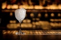 Elegant cocktail glass filled with ice against the bar Royalty Free Stock Photo