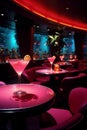 Elegant cocktail glasses on tables with moody red lighting in a modern lounge bar, club or nightclub