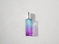 Elegant colored purple with blue rectangular perfume bottle. Cosmetic container with color gradient. Pink perfume botlle Royalty Free Stock Photo