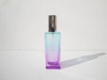 Elegant colored purple with blue rectangular perfume bottle. Cosmetic container with color gradient. Pink perfume botlle Royalty Free Stock Photo