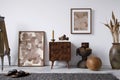 Elegant composition of masculine room decor with small wooden bench, mockup painting and vintage accessories. Home staging.