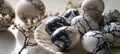 Elegant composition of black and white marble patterned easter eggs on white plate with copy space