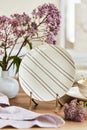 Elegant composition of classy dining room interior design with rustic table, beautiful porcelain, flowers and kitchen accessories. Royalty Free Stock Photo