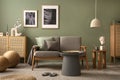 Elegant composition of living room interior. Modern scandi sofa, design pillows, side table, rattan commode and creative personal Royalty Free Stock Photo