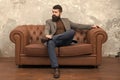 Elegant and confident. Man of fashion. Fashion model relaxing on sofa. Bearded man enjoying casual fashion style Royalty Free Stock Photo