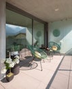 Elegant corner of a terrace of a modern house with two armchairs and a Chinese tea with two cups