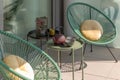 Elegant corner of a terrace of a modern house with two armchairs and a Chinese tea with two cups
