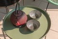 Elegant corner of a terrace of a modern house with two armchairs and a Chinese tea with two cups