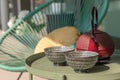 Elegant corner of a terrace of a modern house with two armchairs and a Chinese tea with two cups