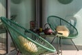 Elegant corner of a terrace of a modern house with two armchairs and a Chinese tea with two cups