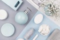 Elegant cosmetics set of accessories for beauty care top view - soap, towel, ceramic pastel blue bowls, silver cosmetic bag. Royalty Free Stock Photo