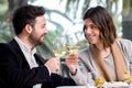 Elegant Couple making toast with white wine in restaurant. Royalty Free Stock Photo