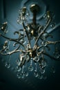 Elegant crystal chandelier is suspended from a ceiling, adorned with a myriad of tiny glass beads.