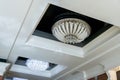 Elegant crystal chandeliers hang on the white ceiling in the lobby of the restaurant. Modern diode lamps inside a retro style lamp