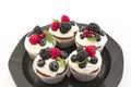 Elegant Cupcakes with Berries on the Black Plate Royalty Free Stock Photo