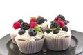 Elegant Cupcakes with Berries on the Black Plate Royalty Free Stock Photo