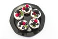 Elegant Cupcakes with Berries on the Black Plate Royalty Free Stock Photo