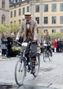 Elegant cycling man wearing old fashioned tweed clothes