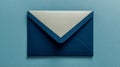 Elegant dark blue envelope with a contrasting white flap placed on a matching light blue background for creative correspondence Royalty Free Stock Photo