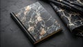 Elegant dark marble-patterned notebook and fabric on a textured surface. Generative AI Royalty Free Stock Photo