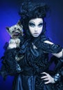 Elegant dark queen with little dog Royalty Free Stock Photo