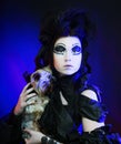 Elegant dark queen with little dog Royalty Free Stock Photo
