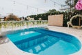 Elegant decorations of beige and white outdoor wedding reception venue by a pool Royalty Free Stock Photo