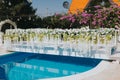 Elegant decorations of outdoor wedding reception venue by a pool Royalty Free Stock Photo