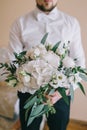 Elegant delicate bouquet of the bride made of white peonies, hydrangeas, roses and green branches Royalty Free Stock Photo