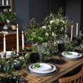 Elegant Dining Table Arrangement with Lush Greenery, Candles, and Sophisticated Tableware for a Memorable Dining Experience Royalty Free Stock Photo