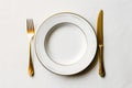 Elegant Dining: White Plate and Golden Cutlery on White Background - Generative AI