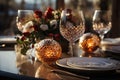 Elegant dinner date table, white plates with cutlery, wine glasses, red flowers, and mood lights, candles, on a bronze