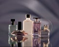 Elegant display of various perfume bottles on a reflective surface with a soft gradient background. Royalty Free Stock Photo