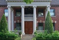 Elegant double wooden front door and entrance with columns