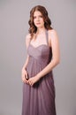 Elegant dress. Beautiful lilac chiffon evening gown. Studio portrait of brunette woman. Royalty Free Stock Photo