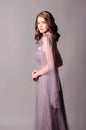 Elegant dress. Beautiful lilac chiffon evening gown. Studio portrait of young woman. Royalty Free Stock Photo