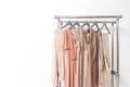 Elegant dress, jumper, trousers and other fashion outfit pastel beige color. Spring cleaning home wardrobe. Copy space