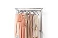 Elegant dress, jumper, trousers and other fashion outfit pastel beige color. Spring cleaning home wardrobe