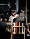 Elegant dressed man hipster at an outdorr restaurant or cafe in the center of Bucharest Royalty Free Stock Photo