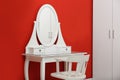 Elegant dressing room interior with makeup table near wall Royalty Free Stock Photo