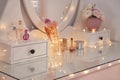 Elegant dressing table with lights in stylish room